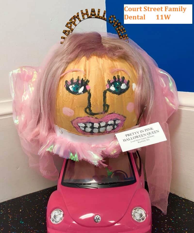 Pumpkin decorated wearing all pink and in a pink car
